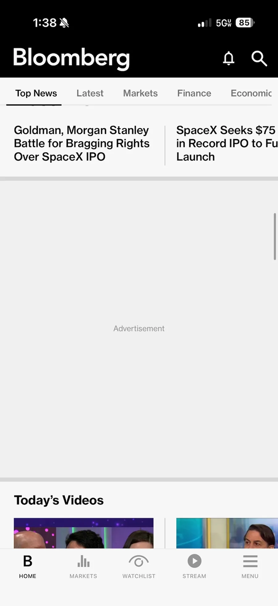 a screenshot of the Bloomberg iOS app with ads blocked and just showing a grey rectangle with the word